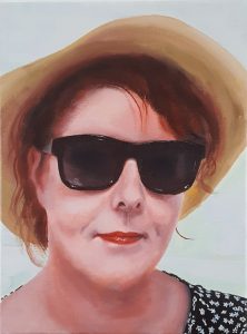 A realistic portrait in oil of a woman.